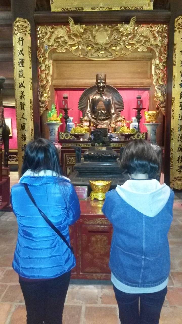 Two girls praying in Hanoi